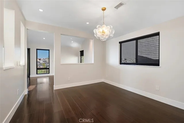 a bathroom with a granite countertop sink two mirror and a bathtub