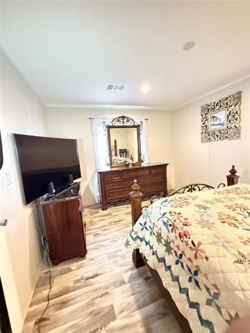 a bedroom with a bed and flat screen tv