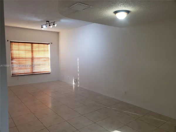 an empty room with a empty space and windows
