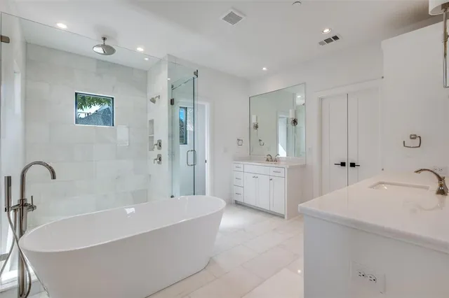 a bathroom with a tub a sink shower and mirror