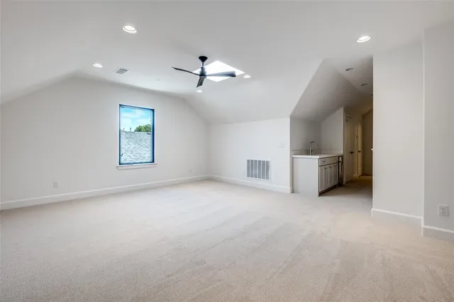 an empty room with windows and ceiling fan