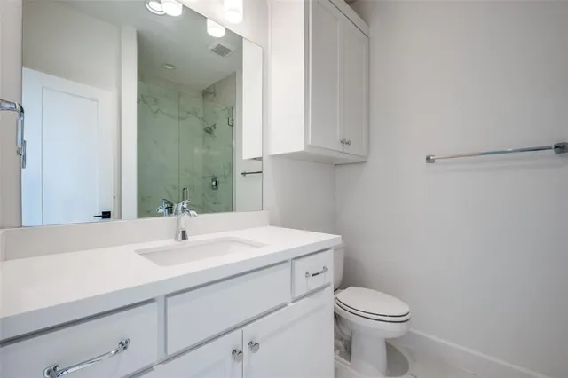 a bathroom with a sink toilet and vanity