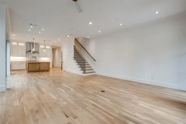 a view of kitchen and hall with wooden floor