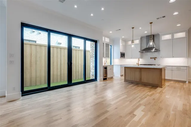 a large kitchen with a large window and stainless steel appliances