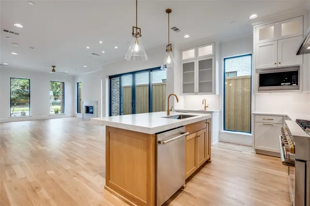 a kitchen with stainless steel appliances granite countertop a stove and a refrigerator