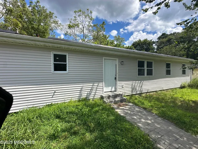 a side view of a house with a yard