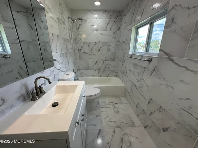 a bathroom with a sink a bathtub and a shower