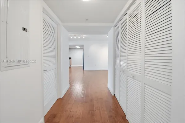 a view of a hallway with wooden floor