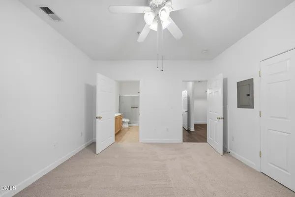 an empty room with a window and a ceiling fan