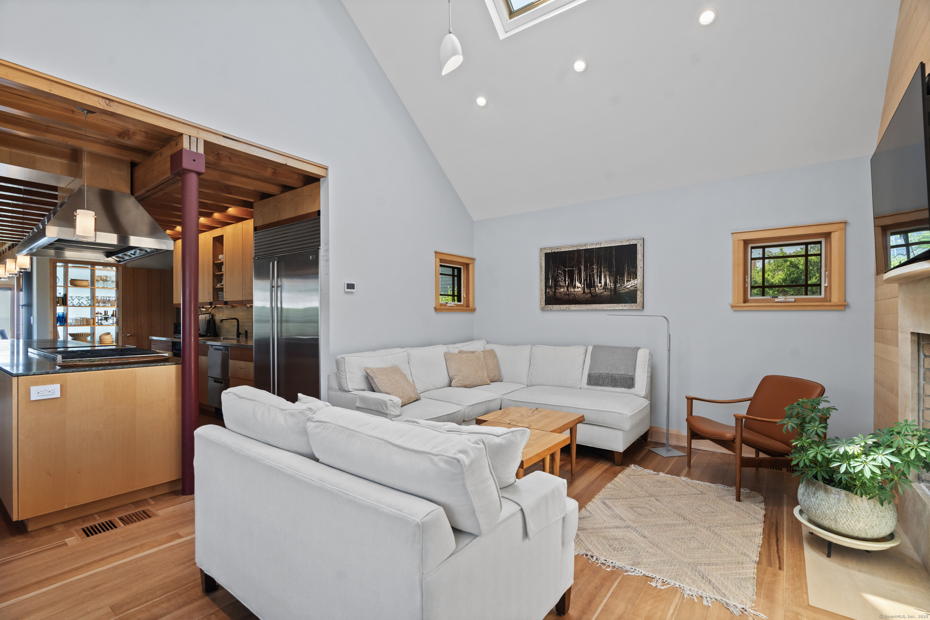 33 Seaview Avenue Madison, CT 06443 - Photo 13 of 40 a living room with furniture and a potted plant
