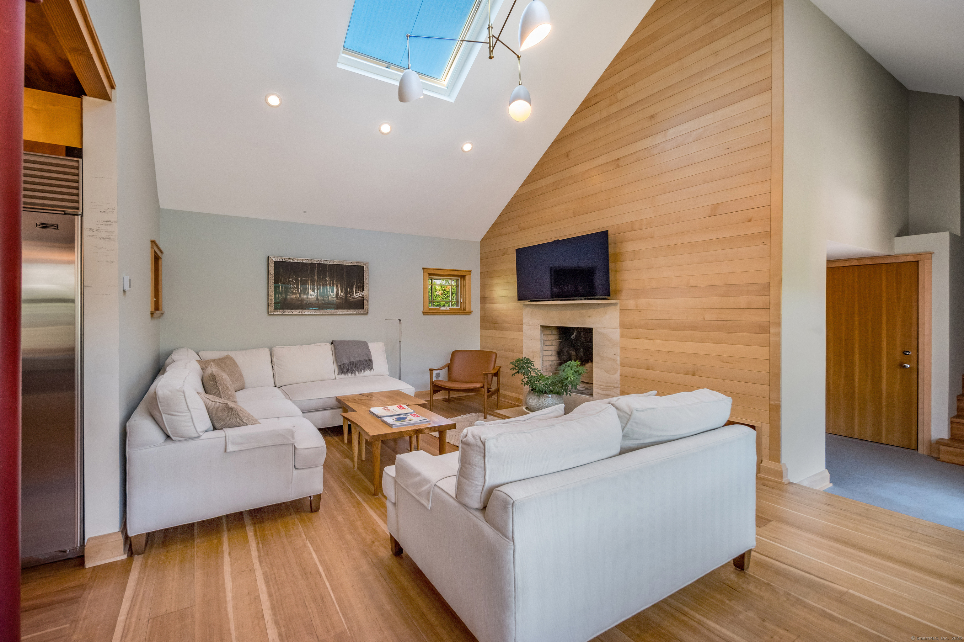 33 Seaview Avenue Madison, CT 06443 - Photo 14 of 40 a living room with fireplace furniture and a flat screen tv