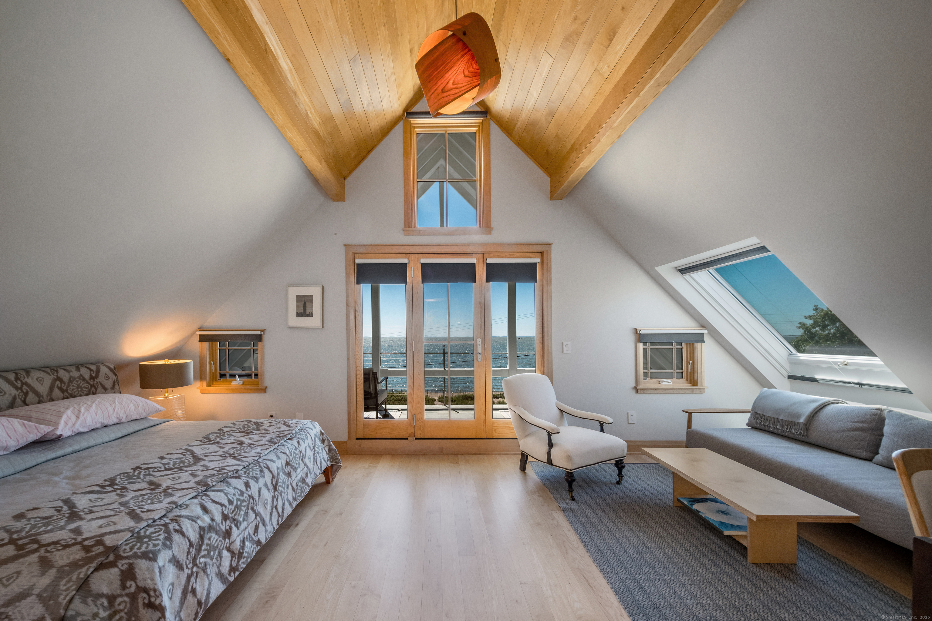 33 Seaview Avenue Madison, CT 06443 - Photo 29 of 40 a bedroom with furniture and a chandelier