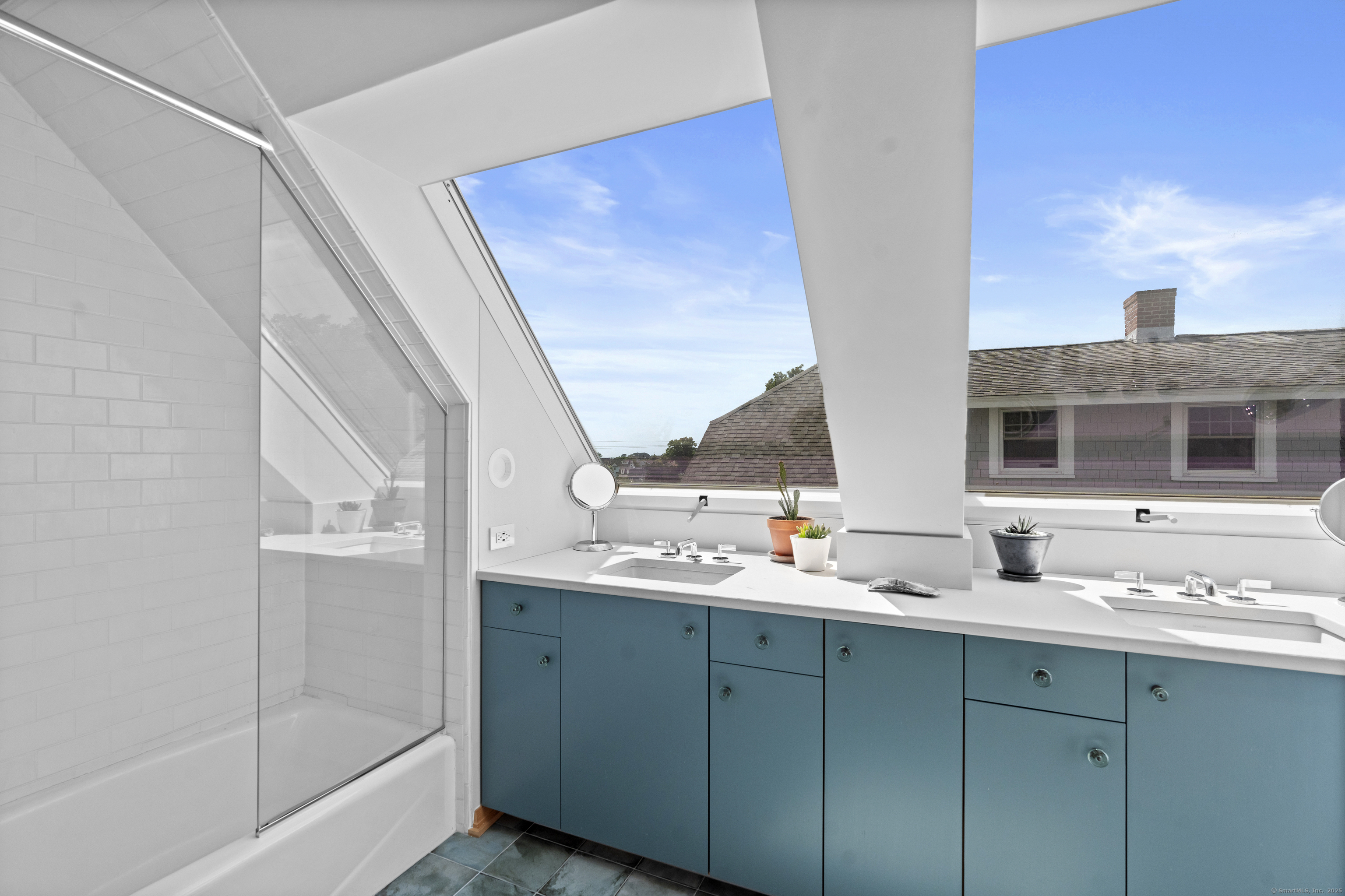 33 Seaview Avenue Madison, CT 06443 - Photo 32 of 40 a bathroom with a double vanity sink and mirror