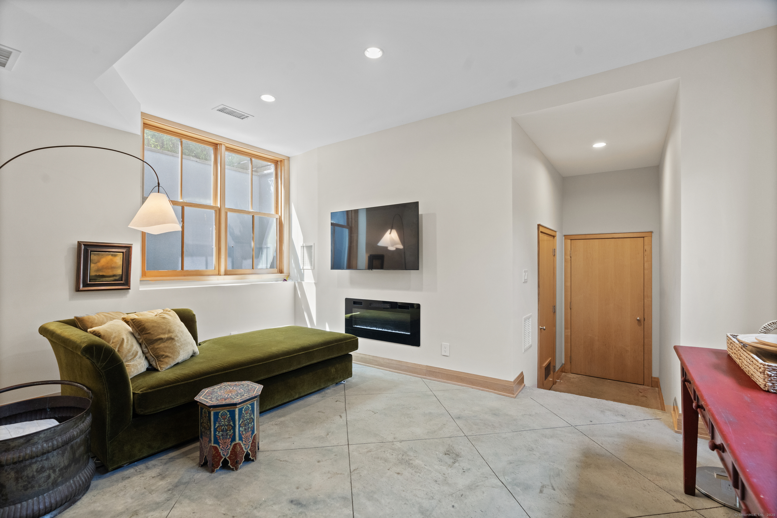 33 Seaview Avenue Madison, CT 06443 - Photo 40 of 40 a living room with furniture a fireplace and a flat screen tv