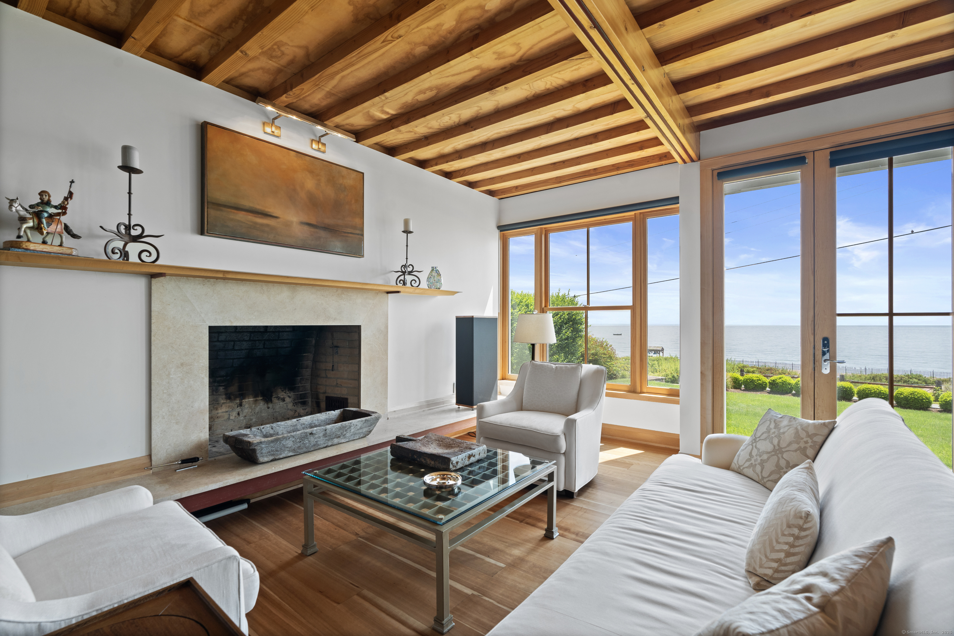33 Seaview Avenue Madison, CT 06443 - Photo 5 of 40 a living room with furniture a flat screen tv and a fireplace
