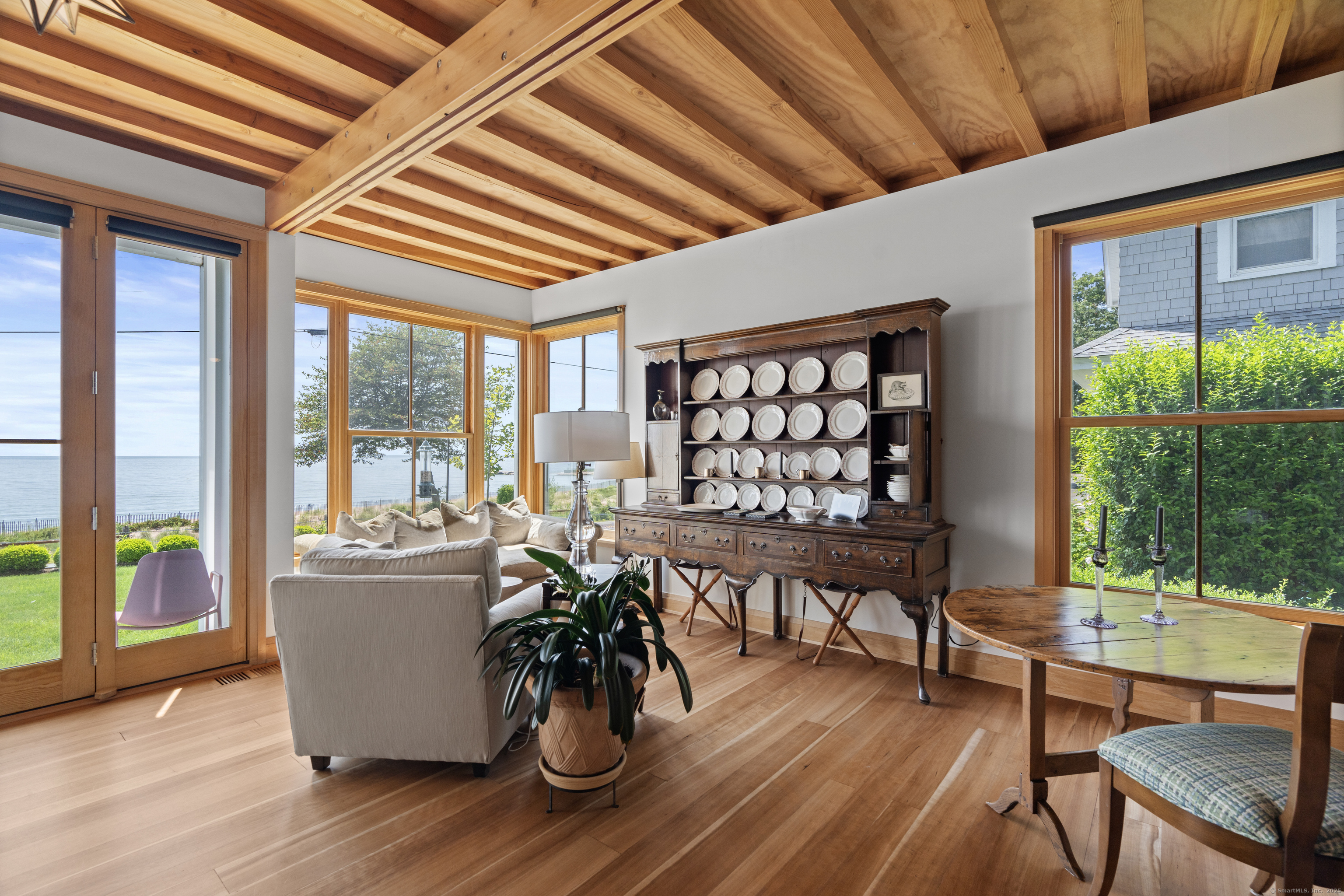 33 Seaview Avenue Madison, CT 06443 - Photo 6 of 40 a dining room with furniture a chandelier and wooden floor