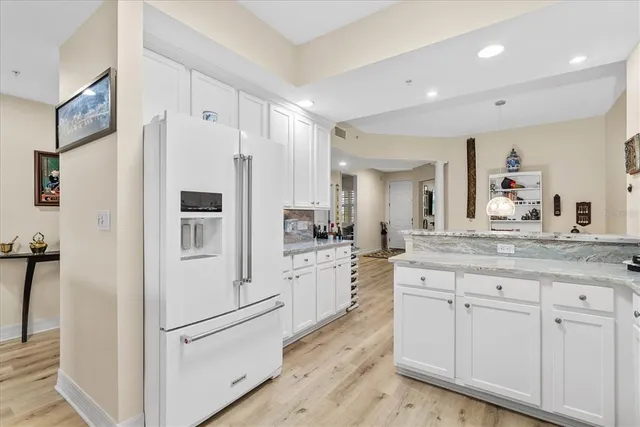 a kitchen with white cabinets and white appliances