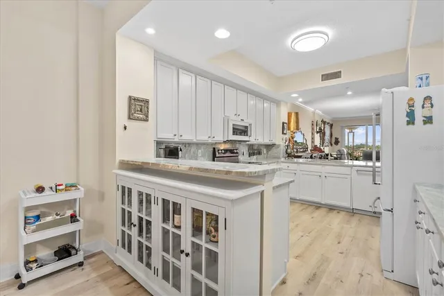 a kitchen with counter top space cabinets and appliances