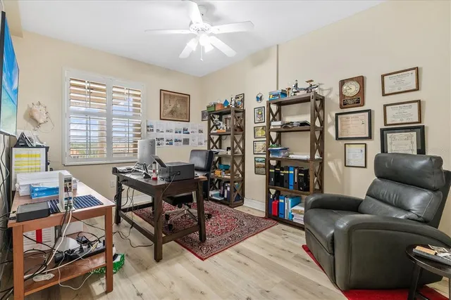 a living room with furniture a flat screen tv and a window