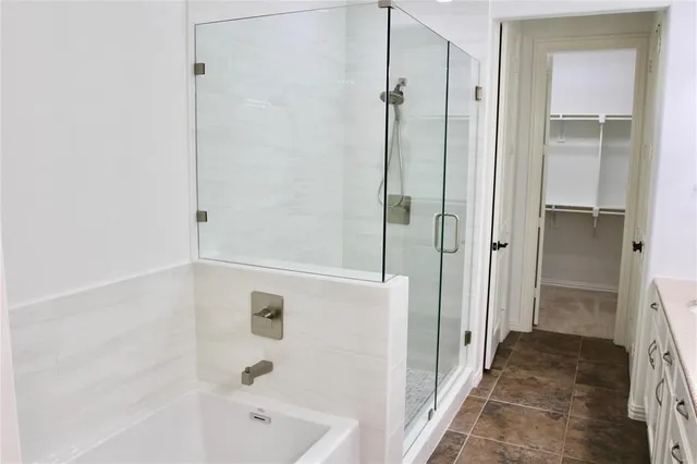 a bathroom with a bathtub and a shower