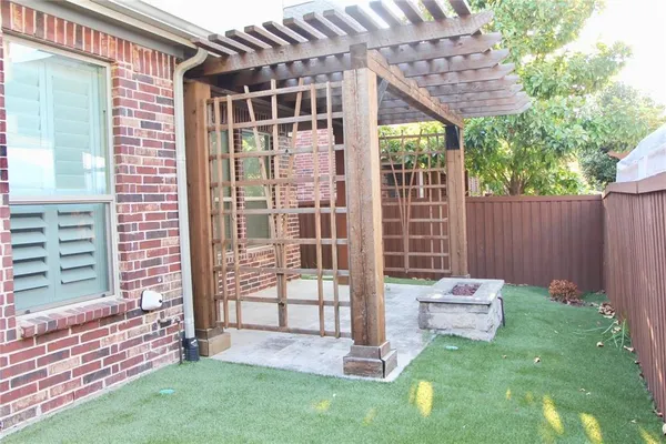 a view of a chair and table in backyard of the house