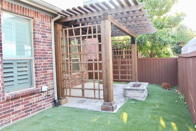 a view of a chair and table in backyard of the house