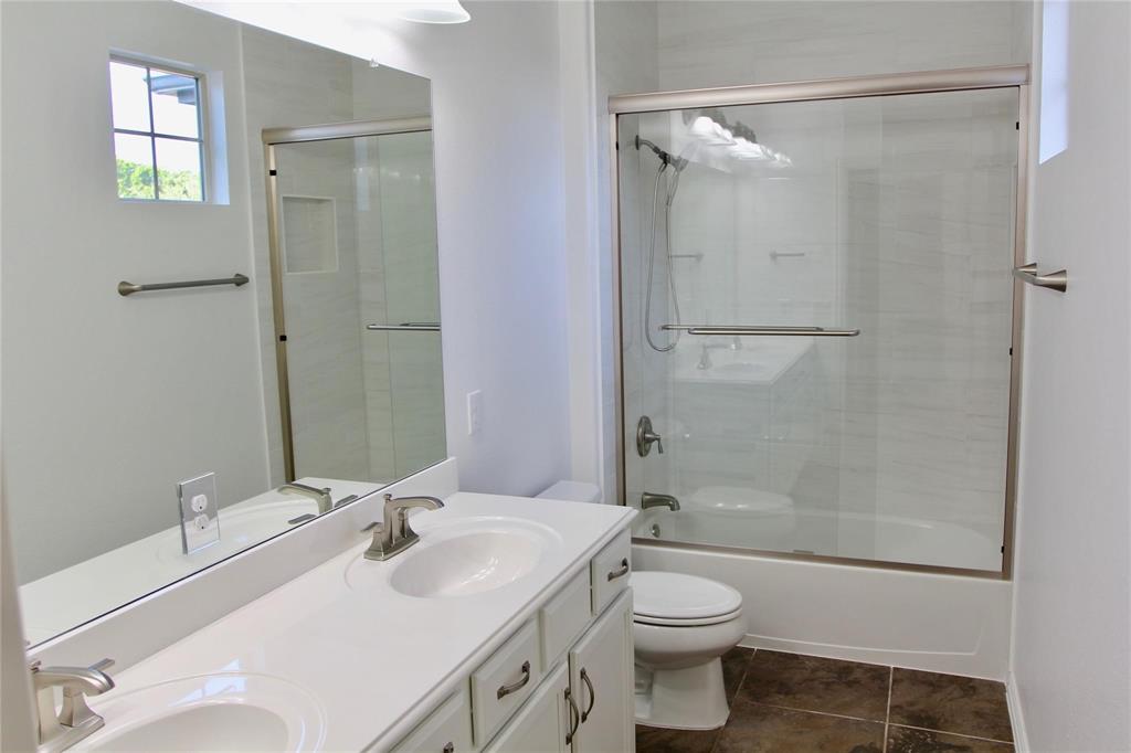 4821 Bayview Drive Plano, TX 75093 - Photo 9 of 21 a bathroom with a sink toilet and shower