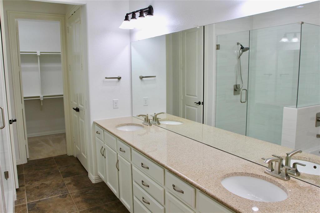 4821 Bayview Drive Plano, TX 75093 - Photo 10 of 21 a bathroom with a double vanity sink mirror double and shower