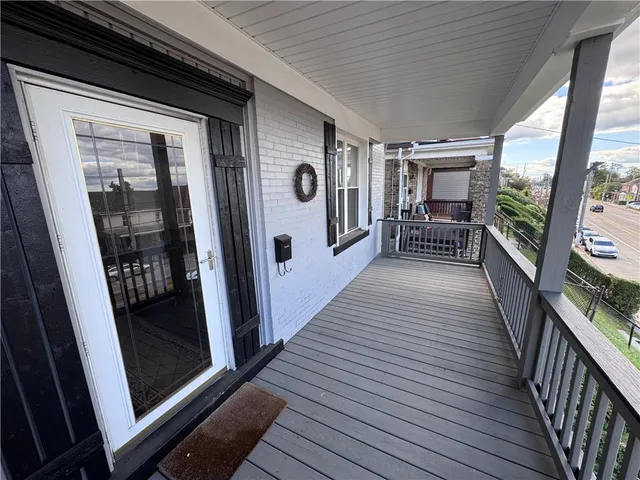 a balcony with chairs and wooden floor