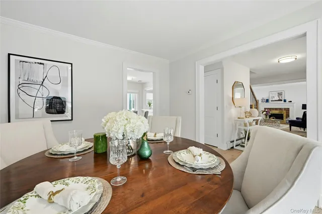 a view of a dining room with furniture a rug and wooden floor