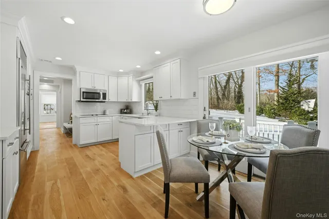 a kitchen with a table chairs refrigerator and cabinets