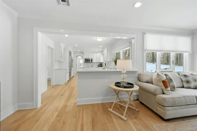 a living room with stainless steel appliances kitchen island granite countertop furniture and a view of kitchen