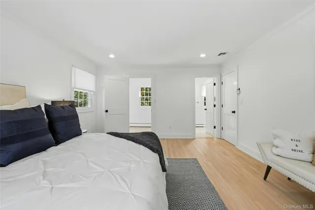 a spacious bedroom with a bed and a desk