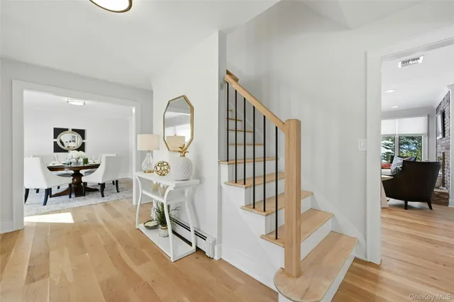 a view of a livingroom with wooden floor and furniture