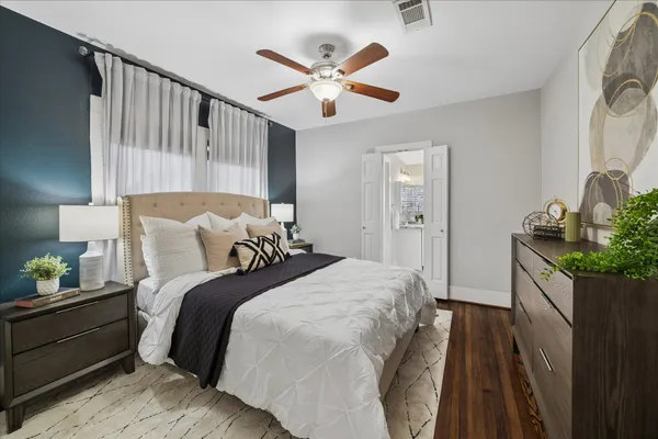 a bedroom with bed and wooden floor