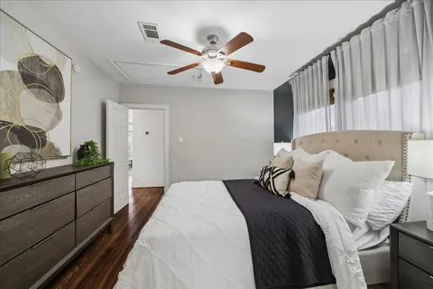 a bedroom with a large bed and a chandelier