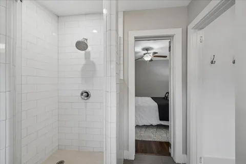 a bathroom with a walk in shower and a bathroom
