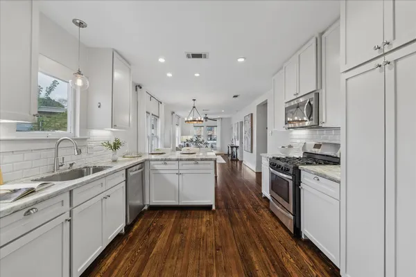 a kitchen with a sink stove and refrigerator