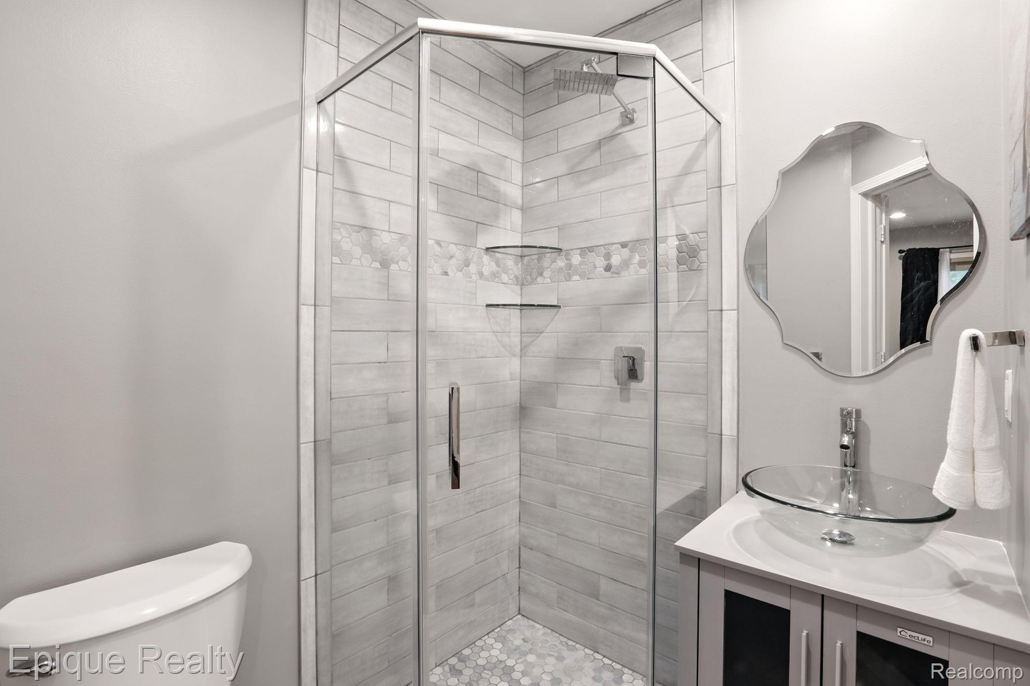 8529 22 Mile Road Utica, MI 48317 - Photo 31 of 40 Bathroom with a stall shower and vanity
