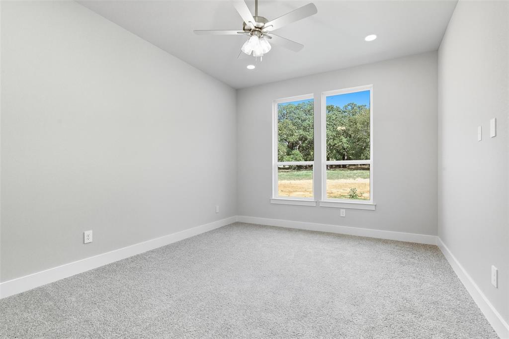 1005 Ronnie Court Springtown, TX 76082 - Photo 21 of 27 Spare room with light colored carpet, ceiling fan, and recessed lighting