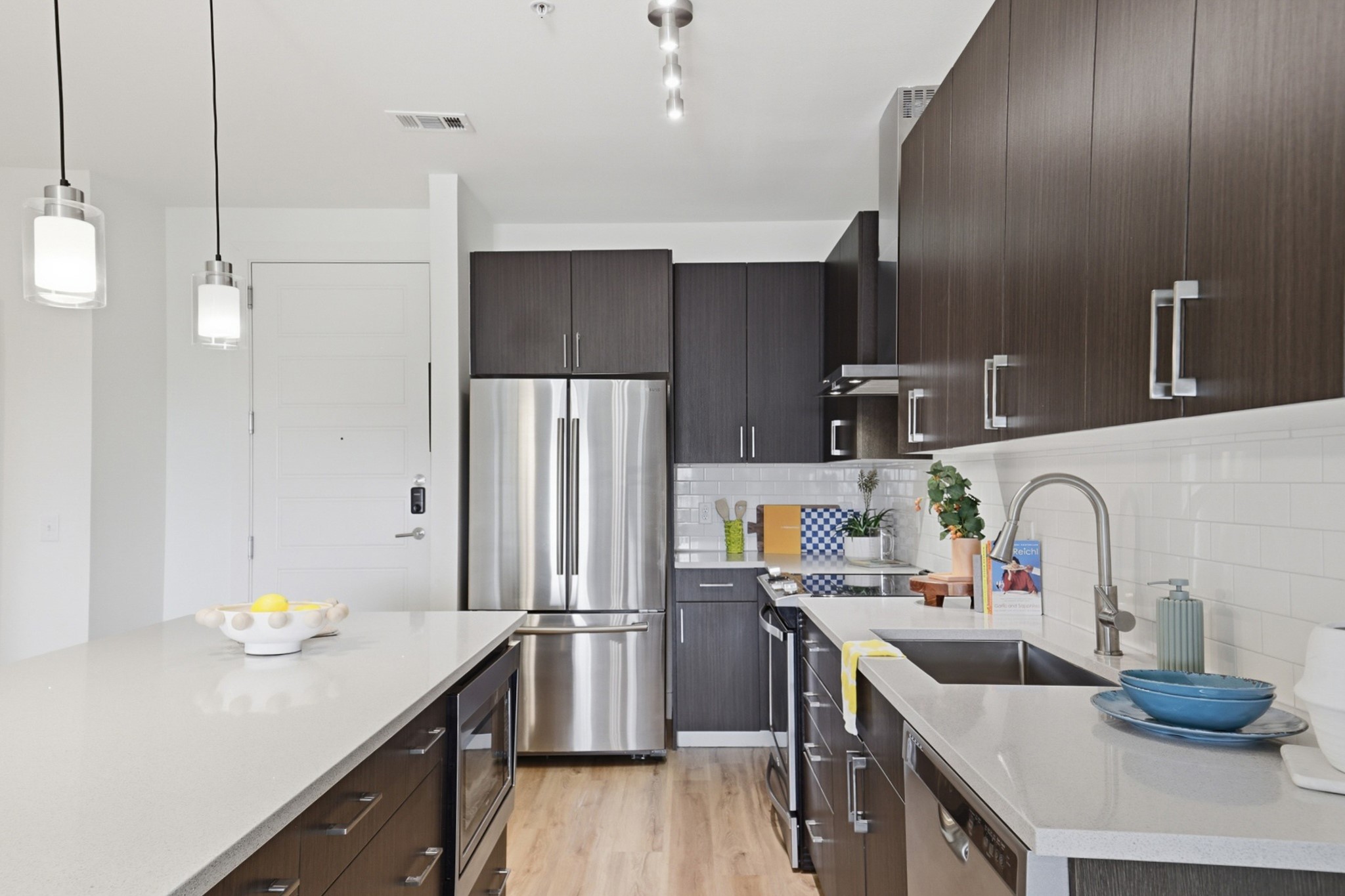 6444 Burnet Road, Unit 403 Austin, TX 78757 - Photo 1 of 29 a kitchen with stainless steel appliances a sink and a refrigerator