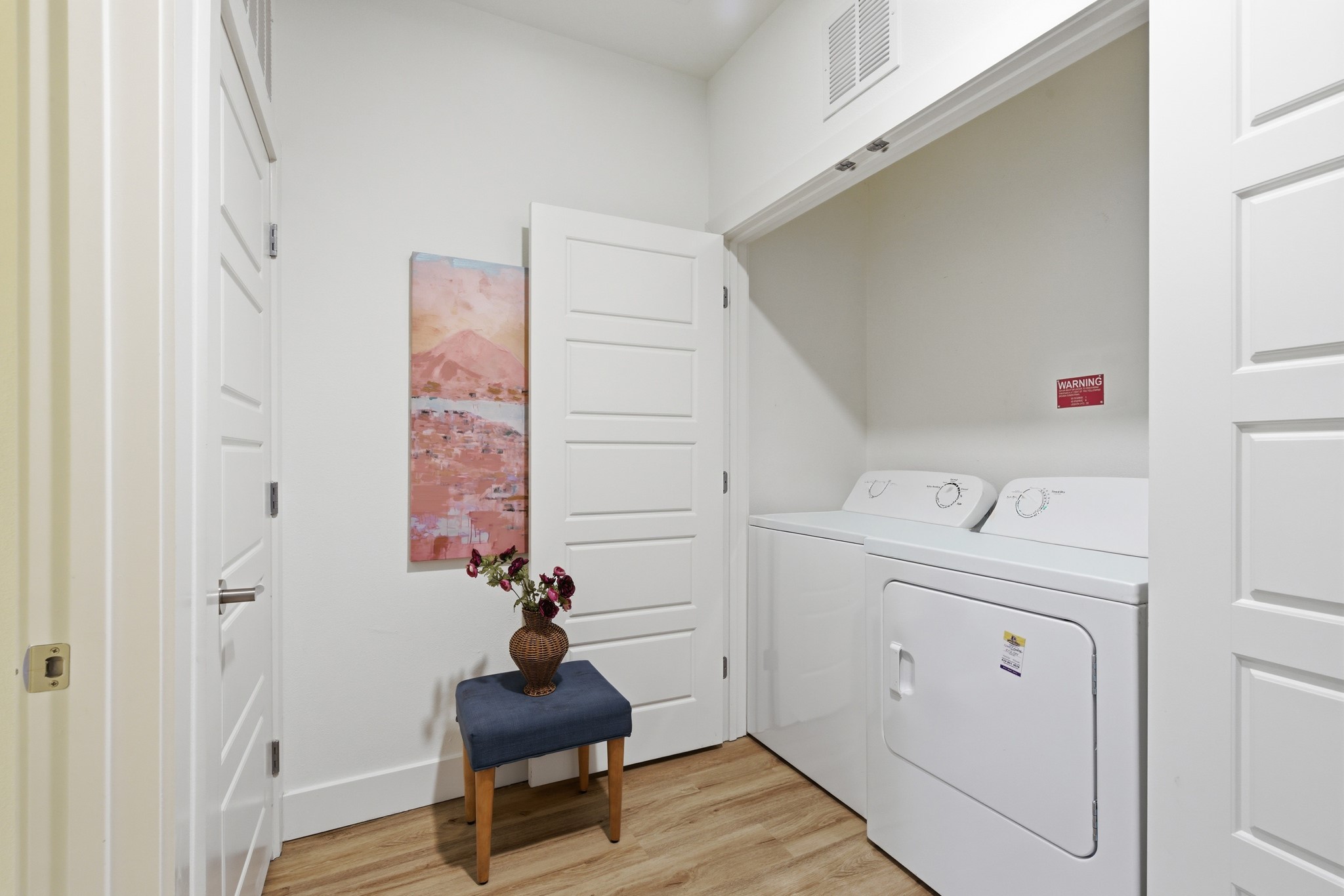 6444 Burnet Road, Unit 403 Austin, TX 78757 - Photo 14 of 29 a room with a washing machine and a wooden floor