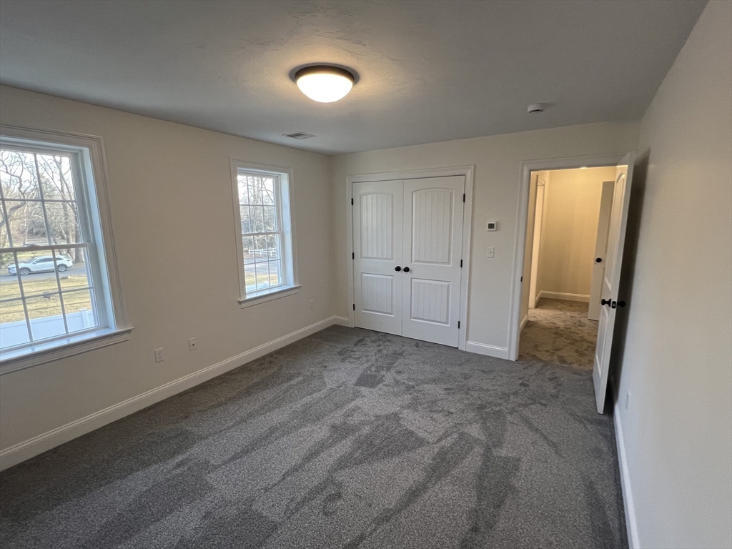 2 Hummingbird Path Watertown, MA 02472 - Photo 15 of 28 an empty room with windows and closet