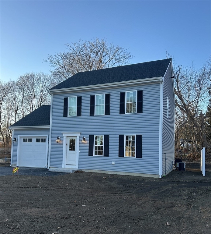 2 Hummingbird Path Watertown, MA 02472 - Photo 2 of 28 a house that has a tree in front of it