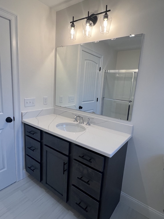 2 Hummingbird Path Watertown, MA 02472 - Photo 26 of 28 a bathroom with a sink and a mirror