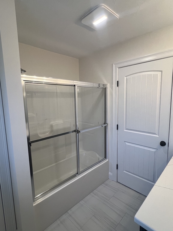 2 Hummingbird Path Watertown, MA 02472 - Photo 27 of 28 a bathroom with a glass shower door