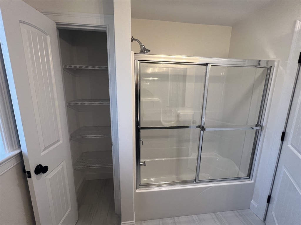 2 Hummingbird Path Watertown, MA 02472 - Photo 28 of 28 a bathroom with a glass shower door