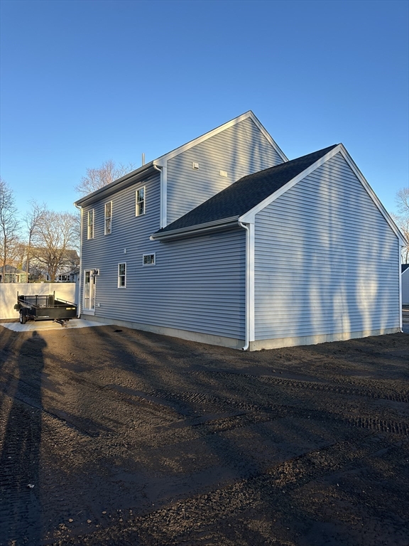 2 Hummingbird Path Watertown, MA 02472 - Photo 3 of 28 a front view of a house with a yard
