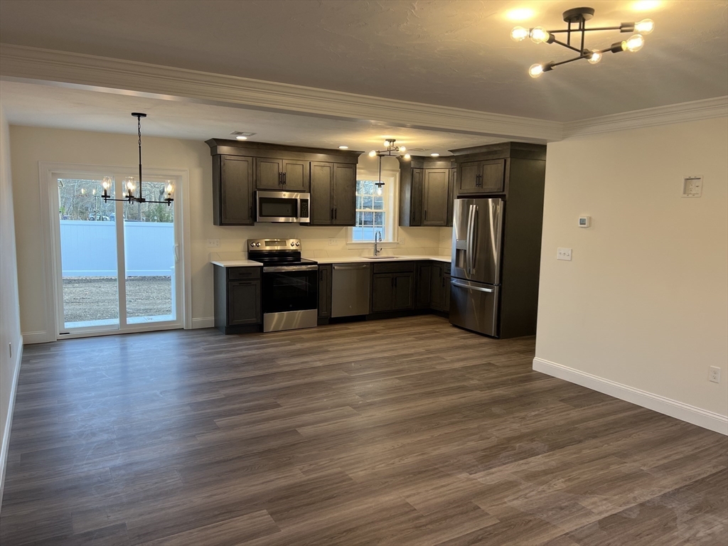 2 Hummingbird Path Watertown, MA 02472 - Photo 5 of 28 a large kitchen with a sink and stainless steel appliances