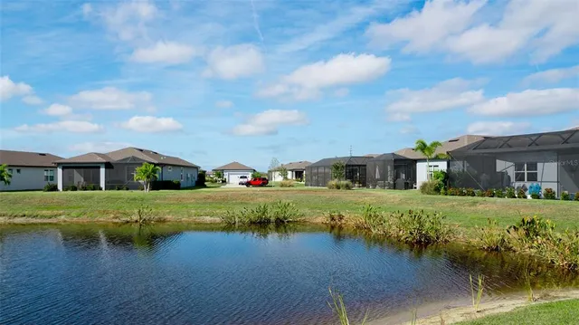 a living room with fireplace furniture and a potted plant